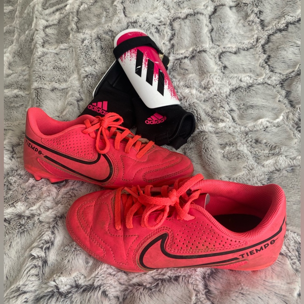 Girls size 2 pink Nike soccer/softball cleats, and pink Adidas shin guards